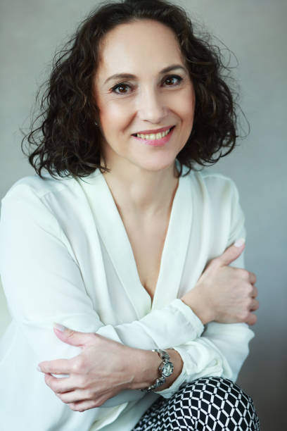 istock woman smiling to camera 700629516