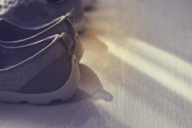 istock Sport shoes on wooden floor with copyspace 700630332