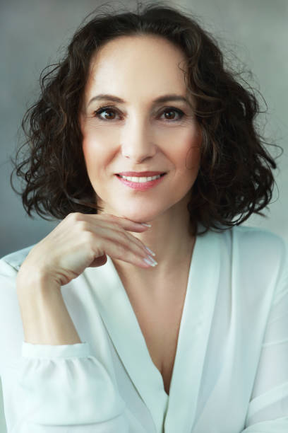 istock woman smiling to camera 700633988