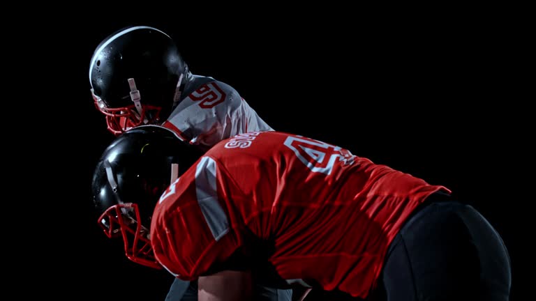 SLO MO American football player holding the ball and defending