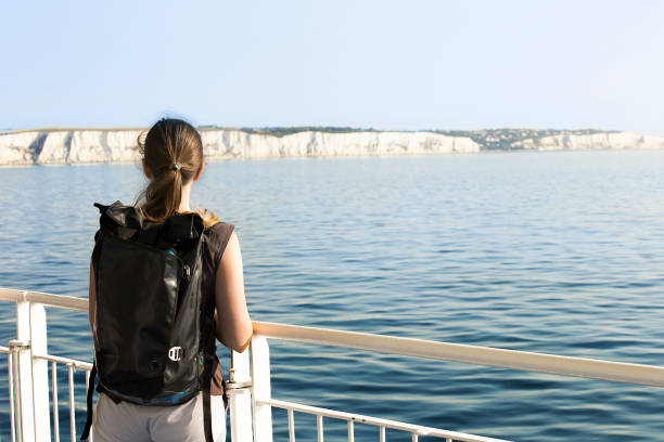 Young woman crossing English Channel by ferry Backpacker crossing La Manche channel from Dover to Calais ferry dover england calais france uk stock pictures, royalty-free photos & images