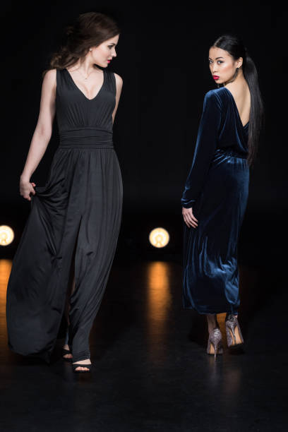 istock confident women with bright makeup in stylish maxi dresses walking together 700641944