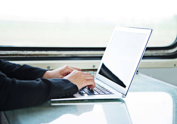 istock Businesswoman on train using laptop 700644662