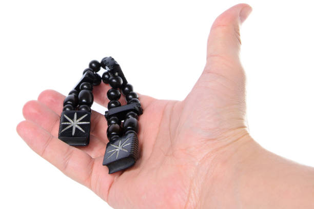 istock Rosary in hand on a white background. Through the glare 700644708