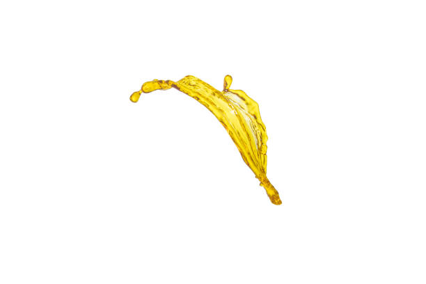 istock beautiful yellow liquid splash isolated over white background 700645380