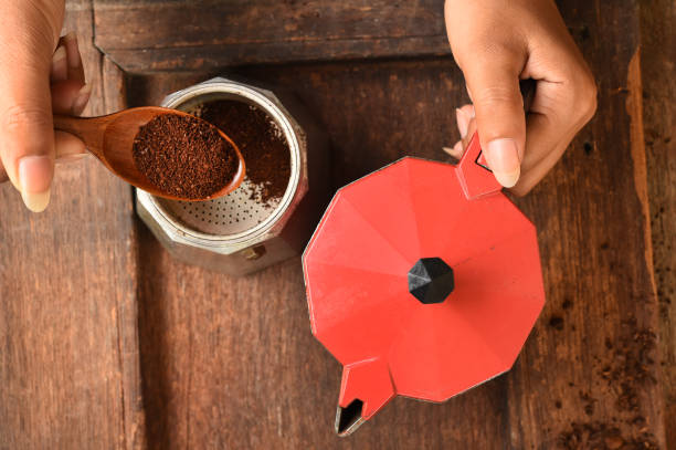 istock Freshly coffee beans in red kettle and ground coffee beans in bowl 700646614