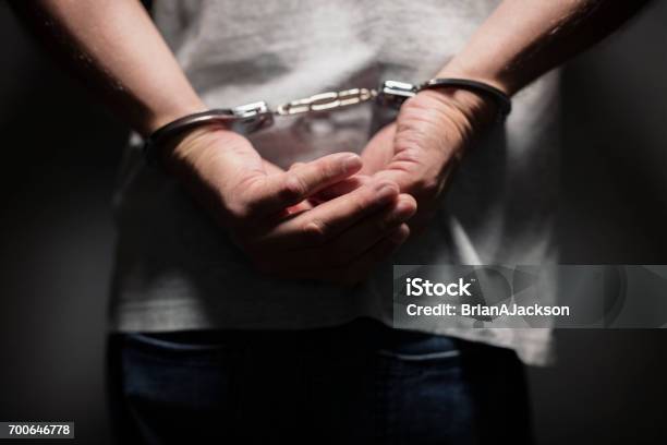 Criminal In Handcuffs Stock Photo - Download Image Now - Police Force, Arrest, Violence