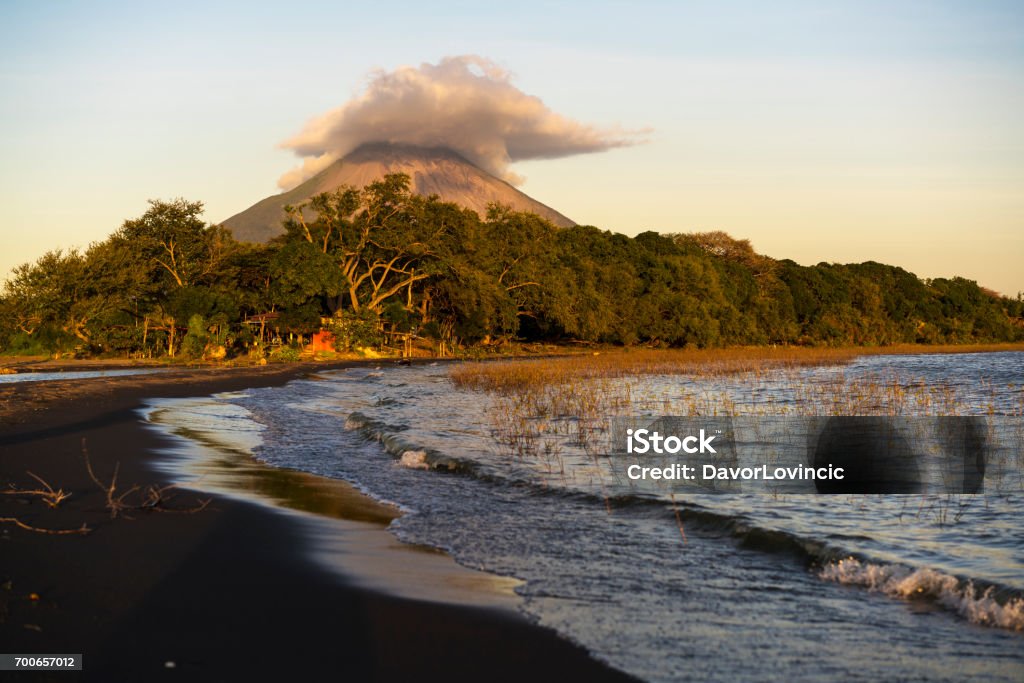 Jesus and Mary beach on island Ometepe in Lake Nicaragua with volcano in background, Nicaragua Jesus and Mary beach on island Ometepe in Lake Nicaragua with volcano Conception in background, Nicaragua in Central America. Volcano Conception is one of the most perfectly shaped volcanos of the Americas and the second highest, 1610 m in Nicaragua and is active volcano with last activity in March 2010. Nicaragua Stock Photo
