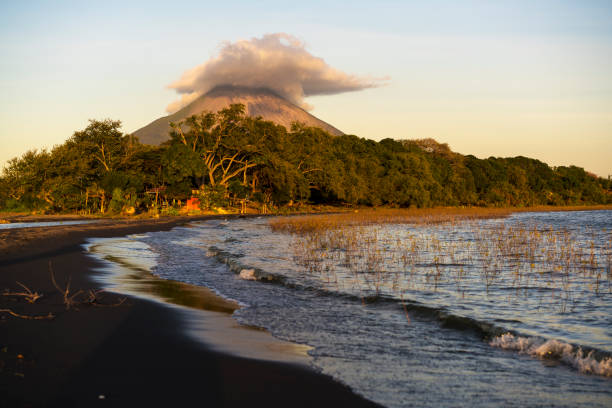 Jesus and Mary beach on island Ometepe in Lake Nicaragua with volcano in background, Nicaragua stock photo