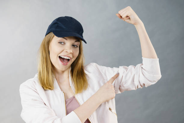 istock Young woman showing her arm muscles 700660734