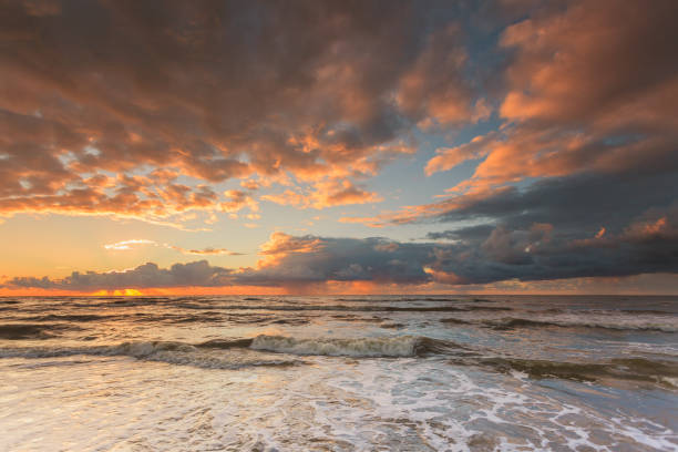 istock Beatiful sunset with clouds over sea and beach 700661766