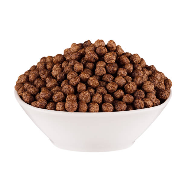 istock Chocolate balls corn flakes in white bowl isolated on white background. Cereals. 700663982
