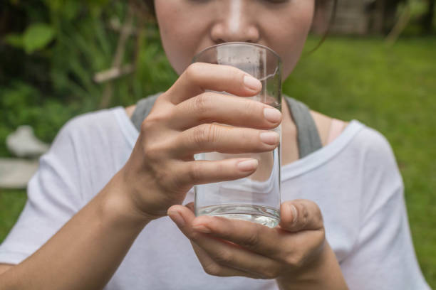 istock Woman drinking water close-up. 700664124
