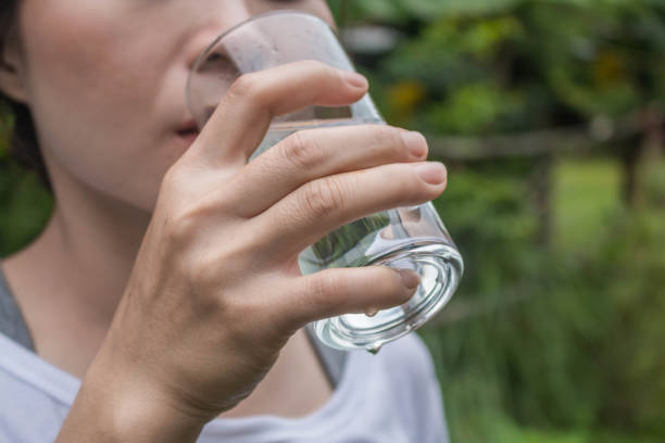 istock Woman drinking water close-up. 700664242