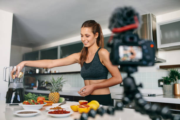 istock Young female blogger recording content for videoblog in Kitchen. 700664472
