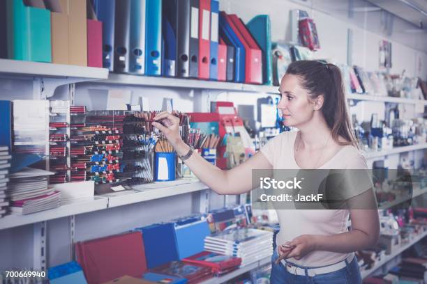 Woman Choosing Color Pencil Different Color Copybook In Stationery Shop Stock Photo - Download Image Now