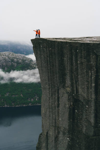 istock Couple standing  on the Preikestolen in Norway 700672418