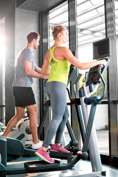 Healthy group of people working out on a elliptic trainer