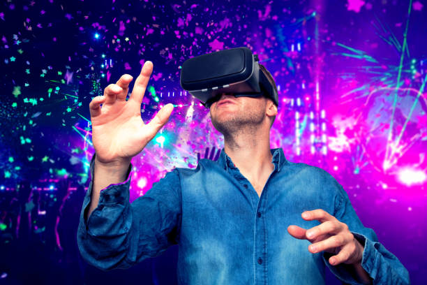 istock Young bearded man wearing virtual reality glasses in modern interior design coworking studio. Smartphone using with VR goggles headset. Horizontal,flares effect, blurred background 700676170