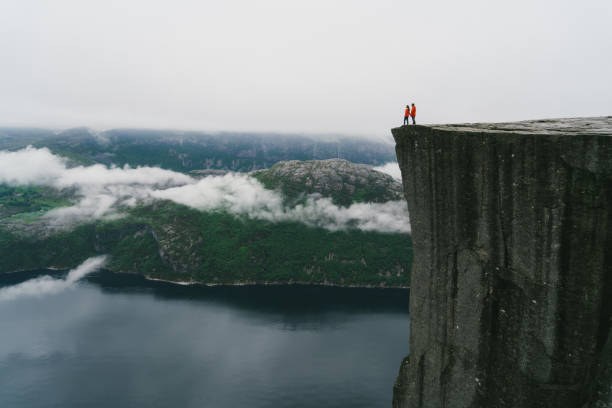 istock Couple standing  on the Preikestolen in Norway 700678044