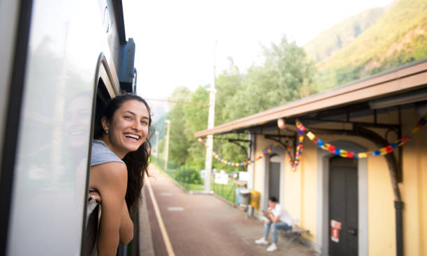 istock Smiling woman looking at the view from train. 700678084