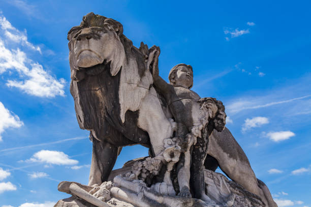 istock Statue Lion a l'enfant at Pont Alexandre III in Paris 700678438