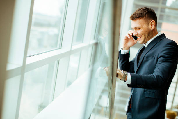 istock Handsome  businessman in classic suit  talking on mobile phone 700685928