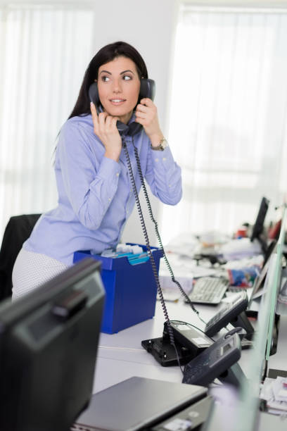 istock Businesswoman using office phone 700688150