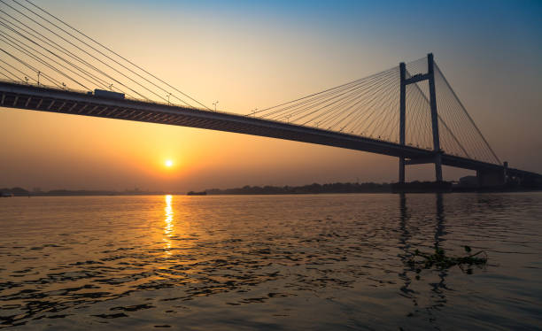 istock Vidyasagar Setu (bridge) - the cable stayed bridge on river Hooghly at sunset. 700689540
