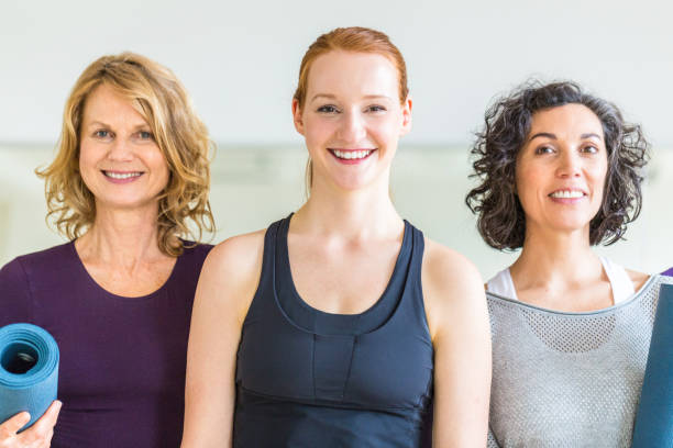 istock Happy women standing together in yoga class. 700718654