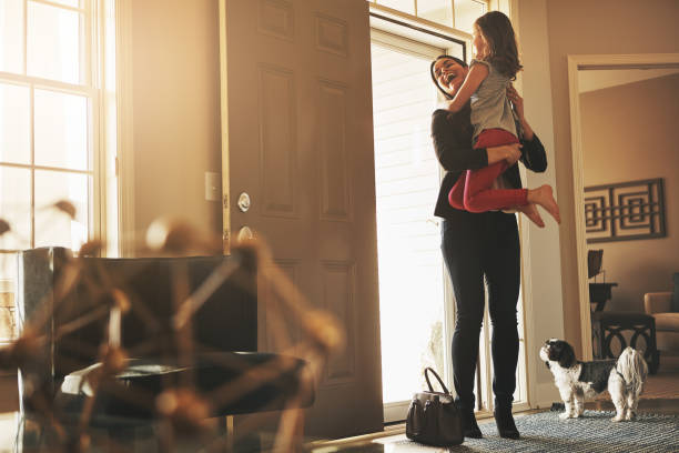 Coming home to her loving arms is worth it Shot of a happy mother arriving home to a loving welcome from her daughter returning home from work stock pictures, royalty-free photos & images