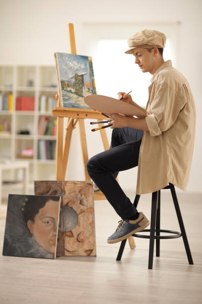istock Teenage painter painting on a canvas 700728806