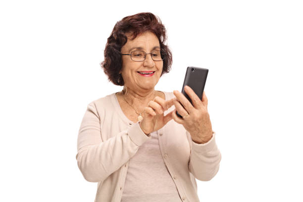 Elderly woman using a phone and smiling
