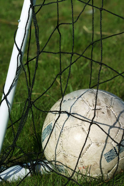 Soccer ball on and grid n grass stock photo