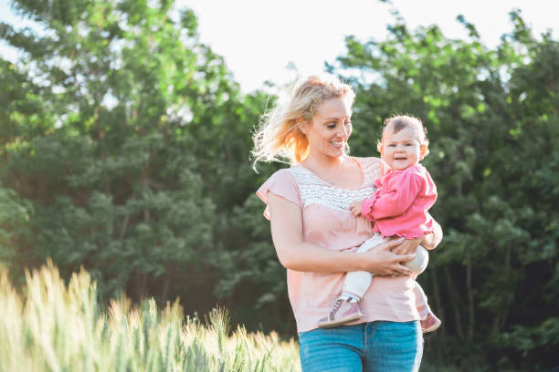 istock Mother with baby by the wheat field 700743288