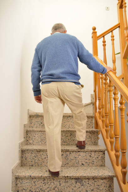 istock senior man climbing the upstairs 700757246