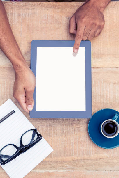istock Person holding on digital tablet by coffee and document 700761474