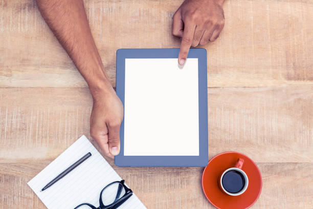 istock Overhead view of person holding on digital tablet 700763788