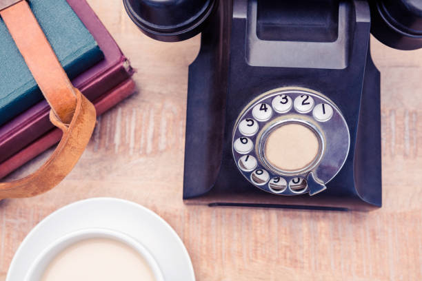 istock Old landline telephone with diaries and coffee 700764128