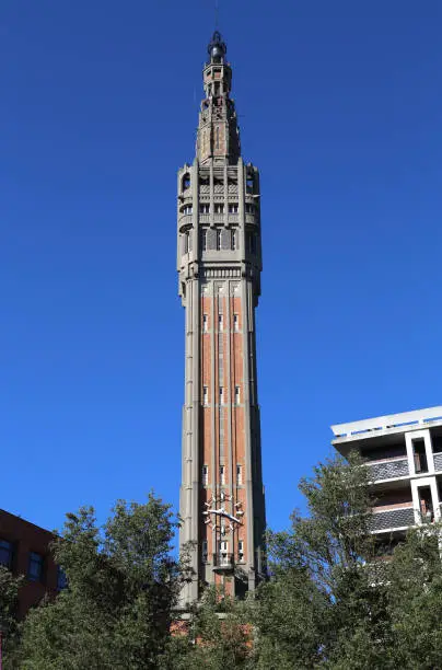 The Belfry of the city hall of Lille, France against a blue sky