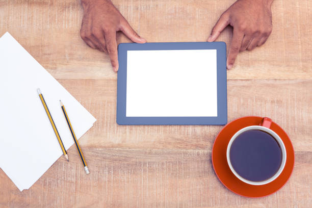 istock Man with digital tablet over table by coffee and papers 700764412