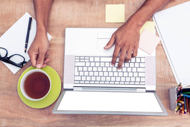 istock Overhead of businessman typing on laptop 700764694