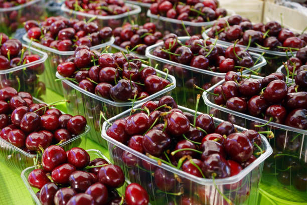 istock cherries in baskets on farmer's market stand 700770612