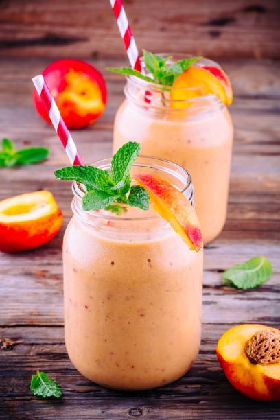 istock Healthy nectarine smoothies in a mason jar with mint on wooden background 700776878