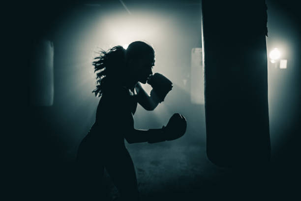 Getting fit with boxing Young woman  boxer with dramatic lighting computer equipment box stock pictures, royalty-free photos & images