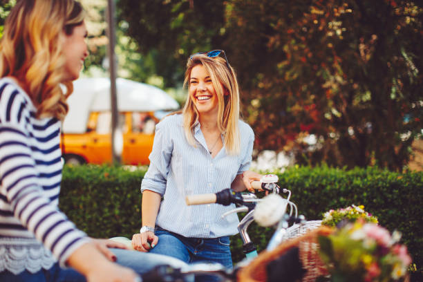 istock Two young women tourists exploring the city on bicycles 700782304