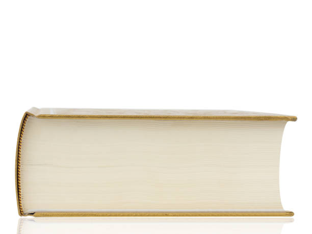 толстая книга с золотой обложкой изолирована на белом фоне. отсечение пути. - paper book cover dirty fashion стоковые фото и изображения
