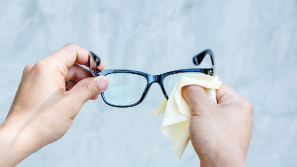 istock Man cleaning the glasses with microfiber fabric. 700788920