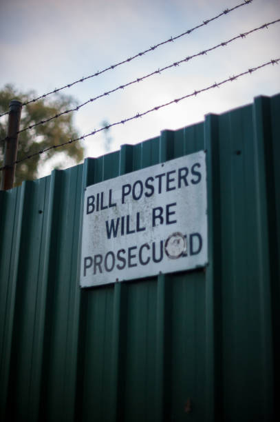 istock old gree fence with sign 700794204