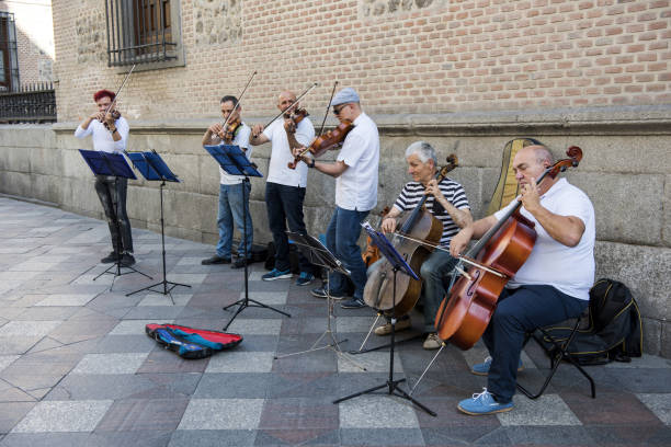 Madrid, Spain - May 25, 2017: Street musicians in Sol Palace (square) at Madrid, Spain. They are playing classic music with some instrument and earning money by using classic musical instruments (violin, cello) in street of Madrid.